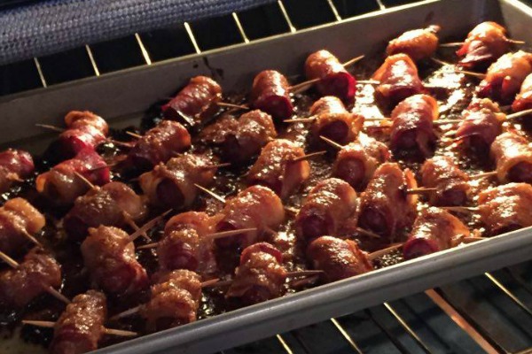 These little smokies wrapped in bacon are simply amazing! You'll never guess what the secret ingredient is! https://couponcravings.com/bacon-wrapped-candied-lil-smokies/