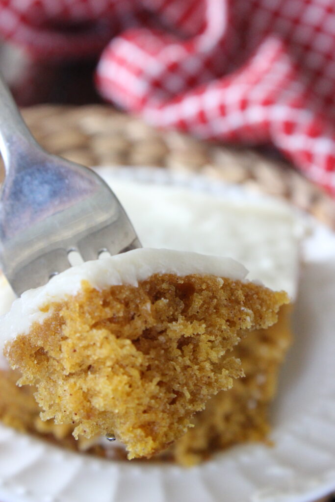 pumpkin bar with cream cheese frosting on a fork