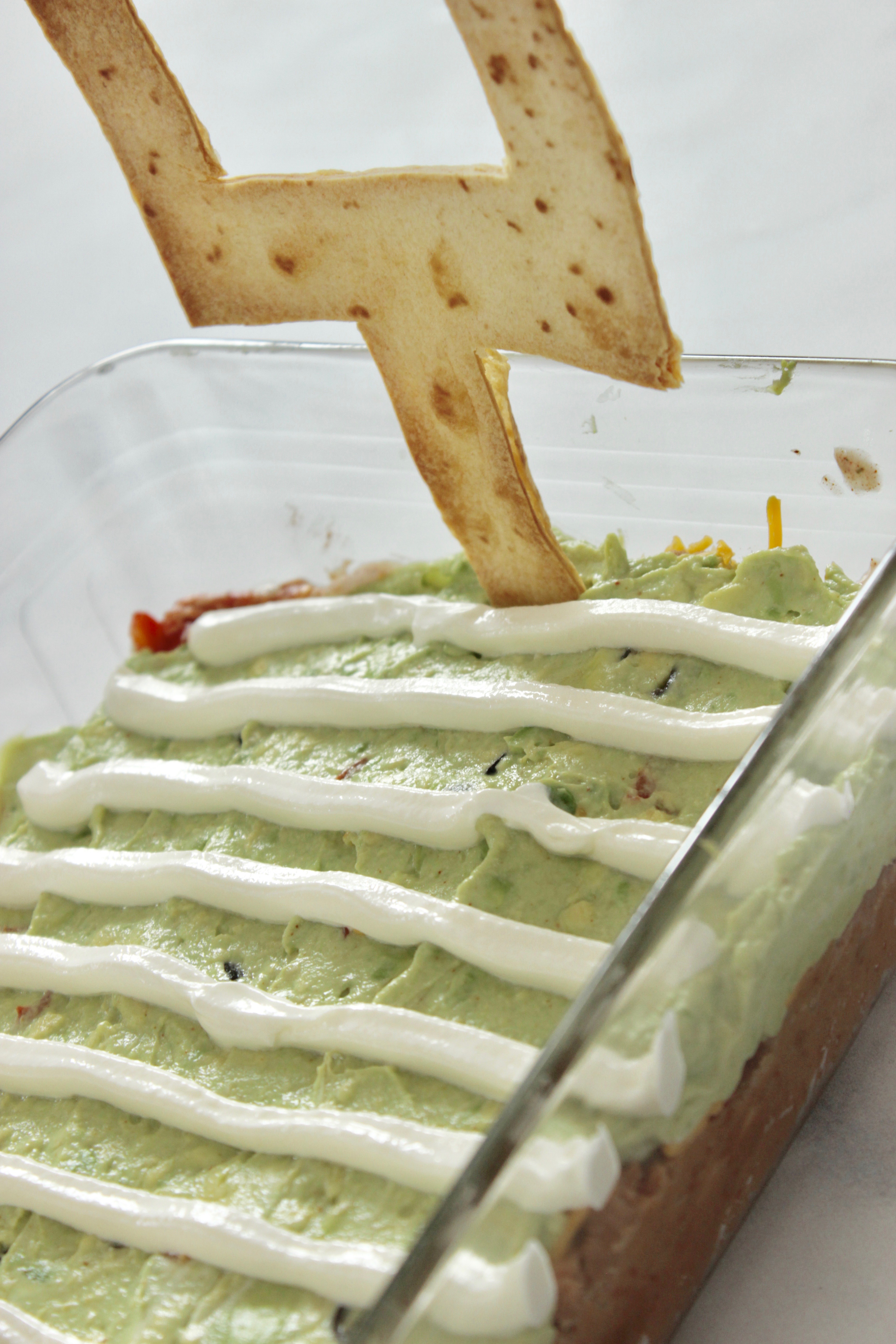 Are you on the hunt for an easy cold taco dip recipe? This is the easy appetizer you're after! And, it's a football themed appetizer so it's cute too! 