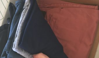 My Men's Stitch Fix Review with all of the clothes in the box. Showing the coral shorts.