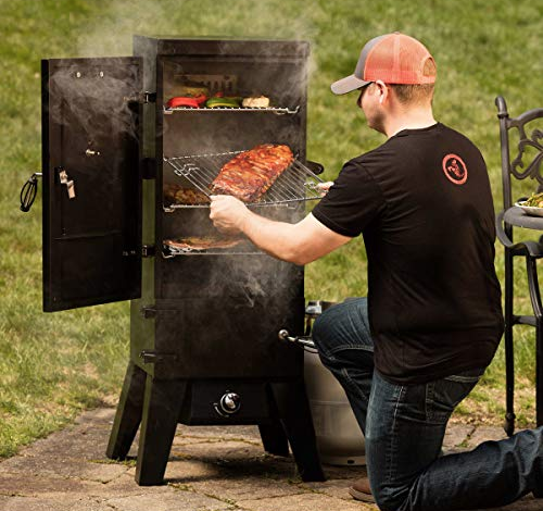 Man at a cuisinart smoker getting food out
