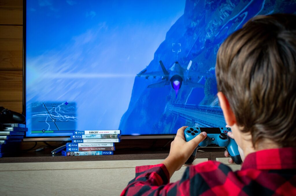 Boy playing video games in an article about gift ideas for 9 year old boys