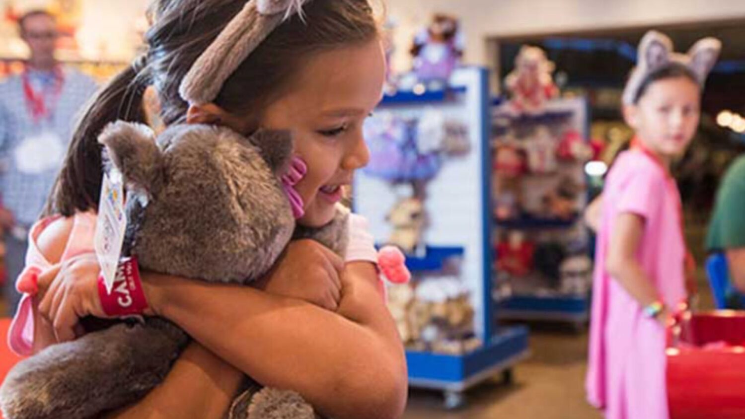 girl hugging a great wolf lodge stuffed animal
