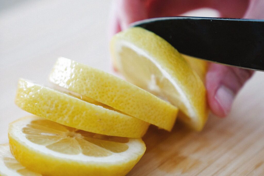 Freshly cut lemon slices on a wood cutting board