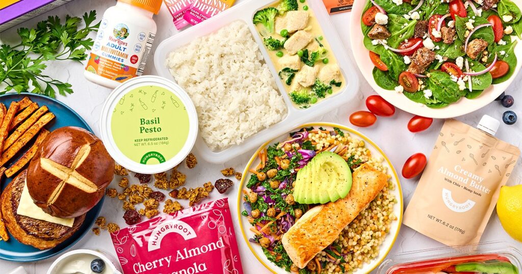 Hungryroot box spread with prepared meals, fresh groceries, and branded snacks